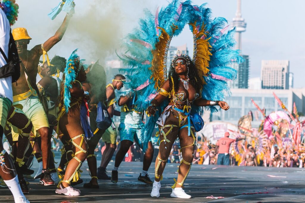 Masqueraders on the stage at the 2023 Toronto Caribbean Carnival with Sunlime Mas. Register to play mas at Toronto Carnival with Sunlime Mas.