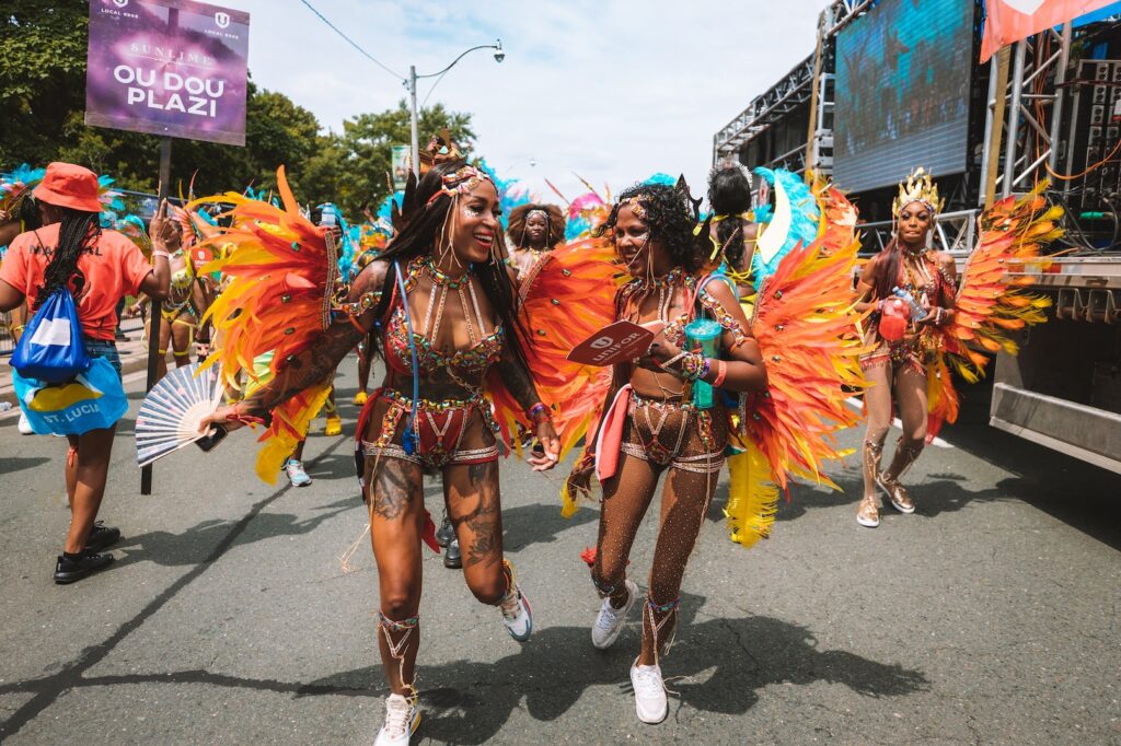 Masqueraders on the Lakeshore at the 2023 Toronto Caribbean Carnival with Sunlime Mas. Register to play mas at Toronto Carnival with Sunlime Mas.